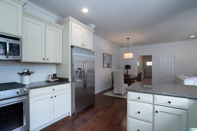 kitchen featuring dark wood-style flooring, tasteful backsplash, dark stone counters, ornamental molding, and stainless steel appliances
