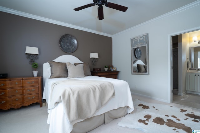bedroom with baseboards, ornamental molding, light carpet, and ensuite bath