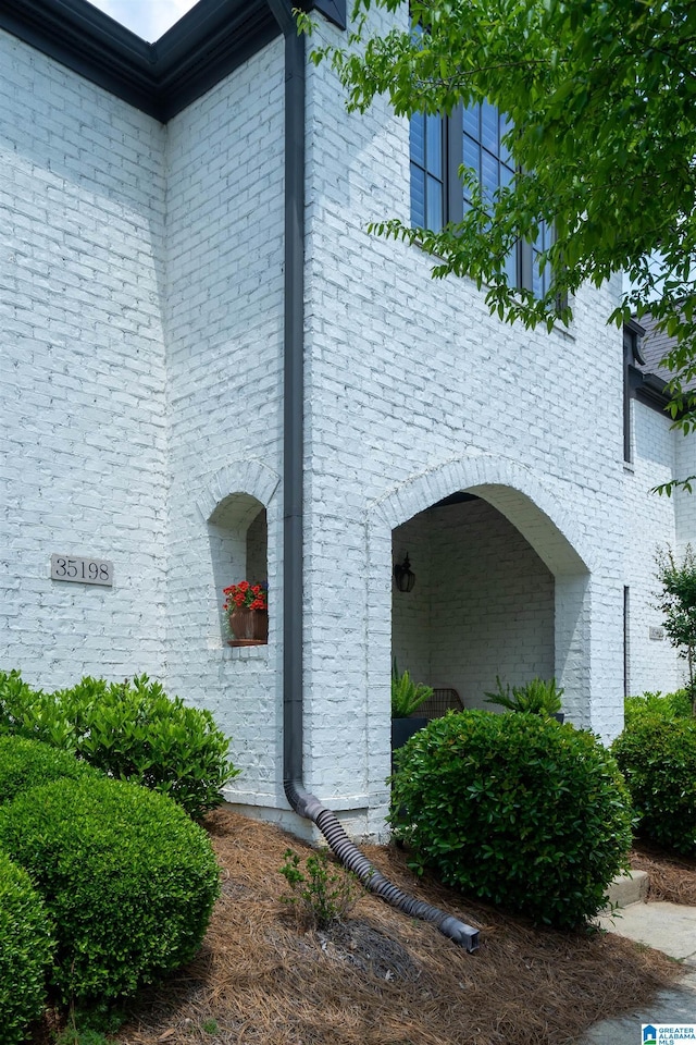 view of side of home with brick siding