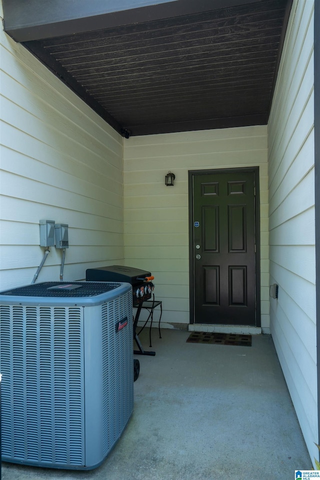 doorway to property featuring central air condition unit