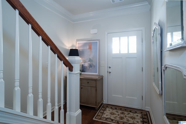 entrance foyer with stairs, dark wood finished floors, ornamental molding, and visible vents