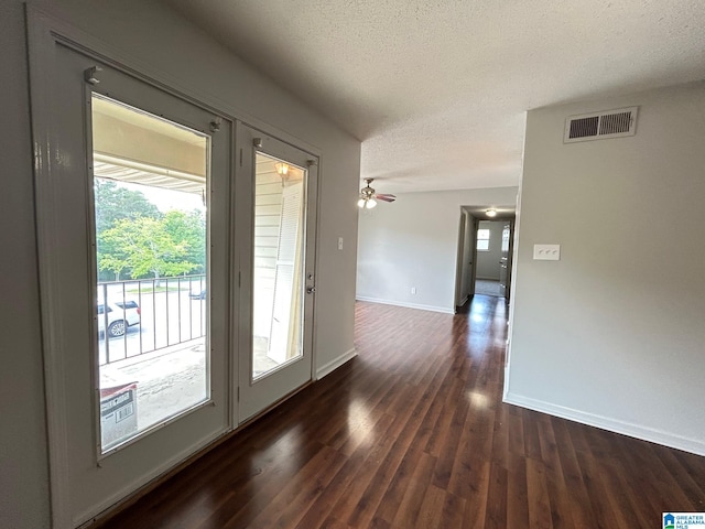 3217 Chase Ln Unit 3217, Birmingham, AL 35215 - doorway featuring visible vents, a textured ceiling, baseboards, and dark wood finished floors