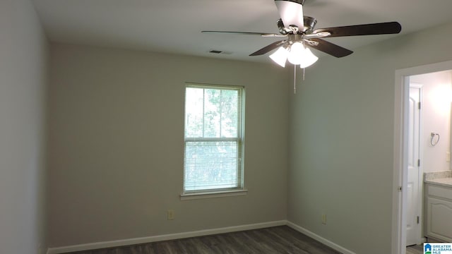 316 Creek Run Cir, Calera, AL 35040 - spare room featuring dark wood-type flooring, a ceiling fan, and baseboards