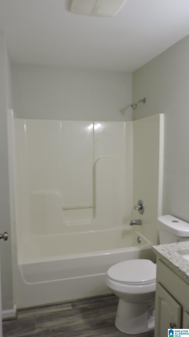 316 Creek Run Cir, Calera, AL 35040 - full bath featuring toilet, wood finished floors, vanity, and washtub / shower combination