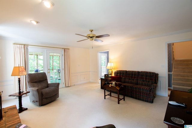 836 Tulip Poplar Dr, Hoover, AL 35244 - living area with light carpet, stairway, ceiling fan, ornamental molding, and a wainscoted wall