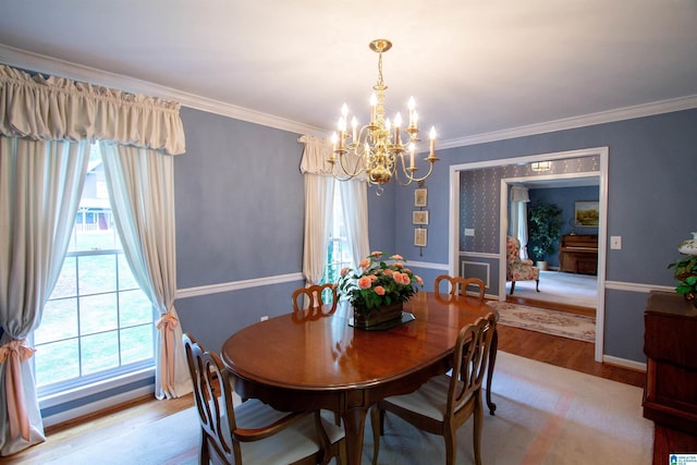 836 Tulip Poplar Dr, Hoover, AL 35244 - dining room with a chandelier, wood finished floors, crown molding, and baseboards