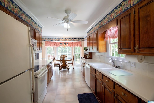 836 Tulip Poplar Dr, Hoover, AL 35244 - kitchen with white appliances, crown molding, light countertops, decorative backsplash, and a sink