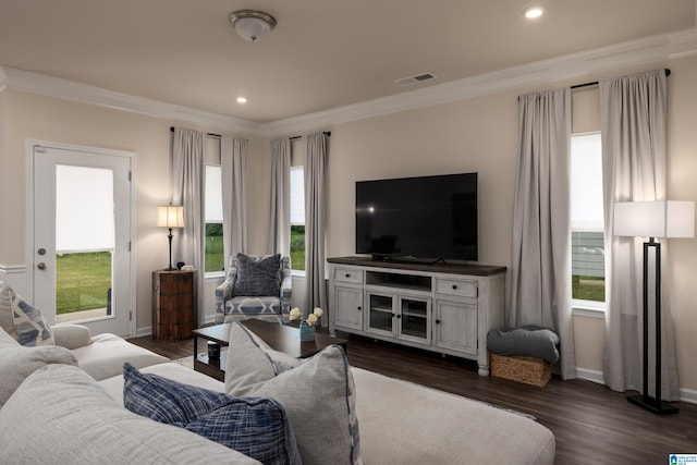 living room featuring visible vents, dark wood-type flooring, baseboards, and crown molding