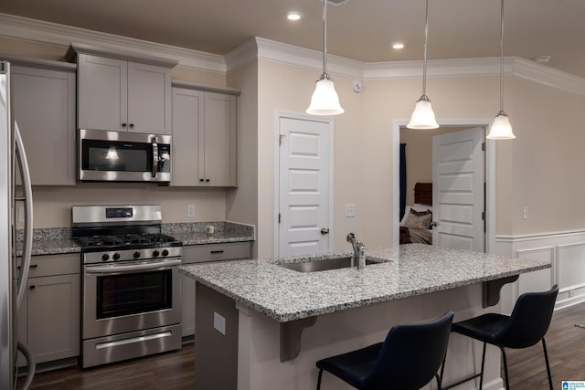 kitchen featuring gray cabinetry, appliances with stainless steel finishes, dark wood-style flooring, and a sink