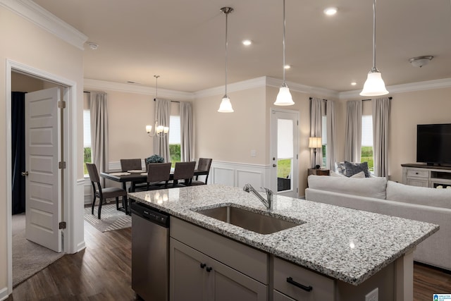 kitchen featuring a sink, a healthy amount of sunlight, open floor plan, and dishwasher