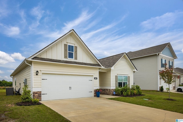 view of front of home with board and batten siding, a front yard, central air condition unit, concrete driveway, and stone siding