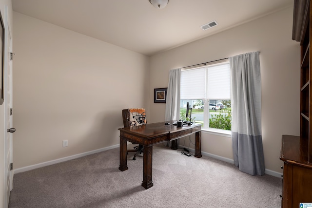 office area featuring visible vents, baseboards, and light colored carpet