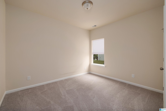 spare room featuring baseboards, carpet, and visible vents