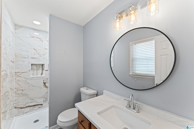 full bath with vanity, a stall shower, and toilet