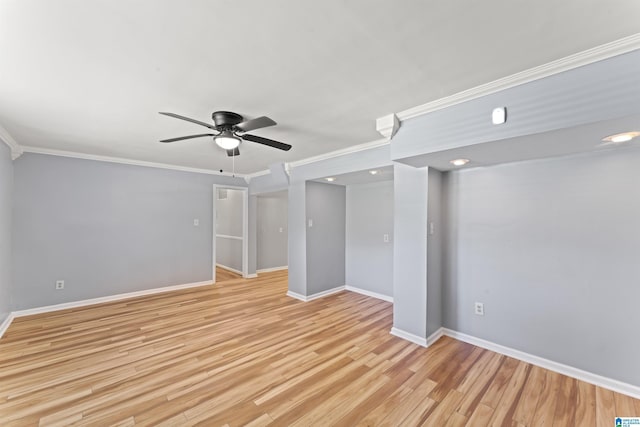 empty room featuring baseboards, a ceiling fan, and crown molding