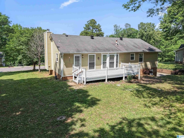 back of house with a lawn, crawl space, a chimney, and a shingled roof
