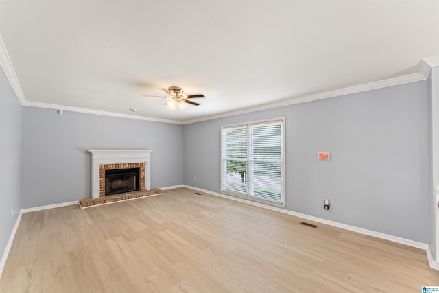 unfurnished living room with crown molding, light wood finished floors, ceiling fan, and baseboards