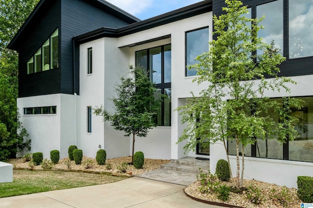 view of side of home with stucco siding