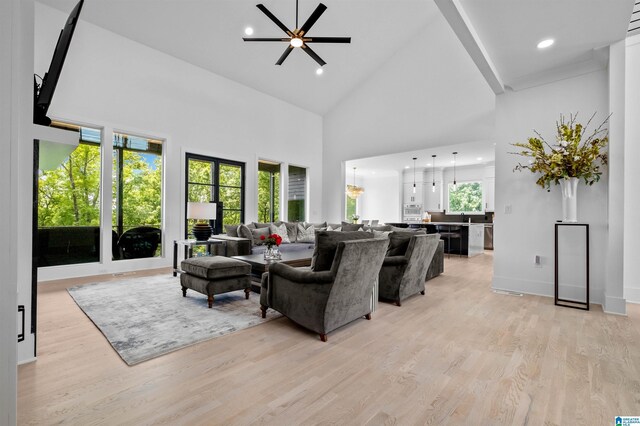living room featuring light wood-style floors, high vaulted ceiling, ceiling fan, recessed lighting, and baseboards