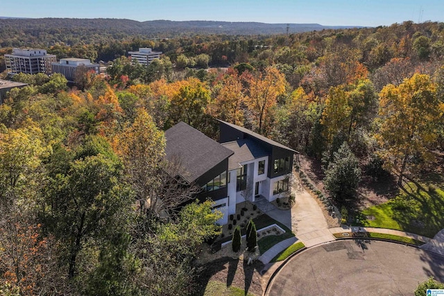 view of subject property featuring a heavily wooded area