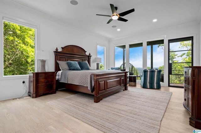 bedroom with multiple windows, access to exterior, light wood finished floors, crown molding, and recessed lighting
