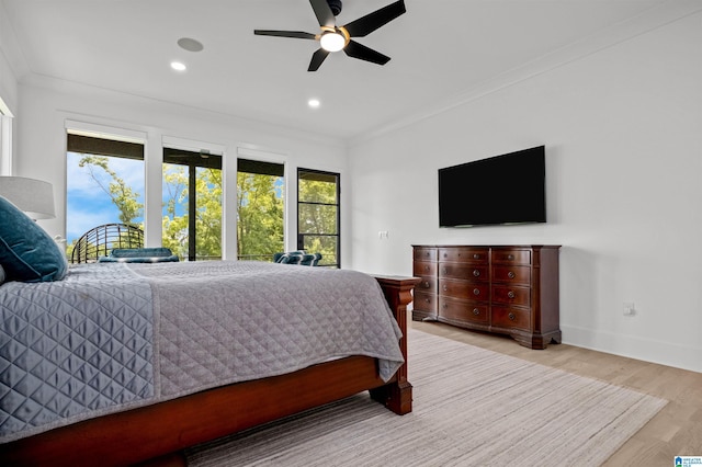 bedroom with wood finished floors, crown molding, recessed lighting, baseboards, and a ceiling fan