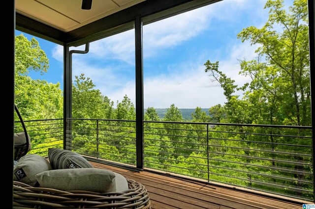 sunroom featuring ceiling fan