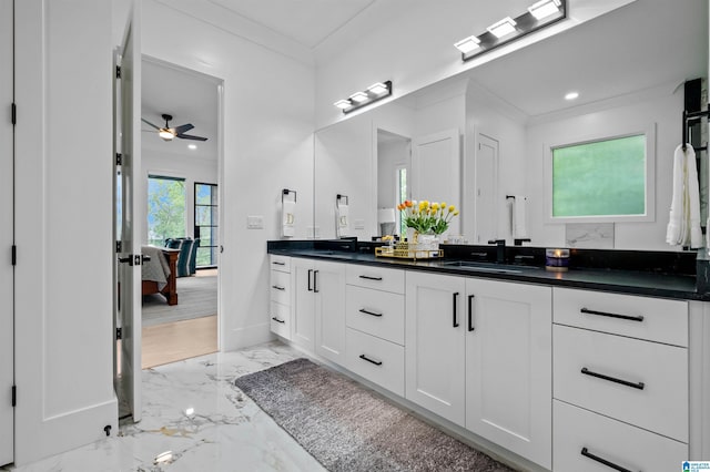 ensuite bathroom with marble finish flooring, a ceiling fan, double vanity, baseboards, and recessed lighting