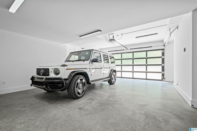 garage featuring a garage door opener and baseboards