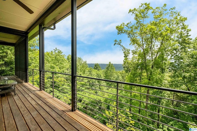 unfurnished sunroom featuring a ceiling fan