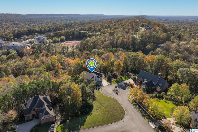 aerial overview of property's location with a heavily wooded area