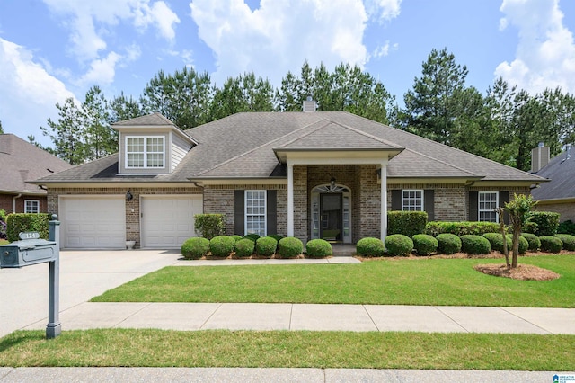 124 Blackstone Ct, Chelsea, AL 35043 - view of front facade featuring driveway, a front yard, roof with shingles, brick siding, and an attached garage