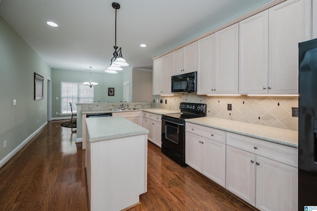 124 Blackstone Ct, Chelsea, AL 35043 - kitchen with decorative backsplash, black appliances, a peninsula, and a chandelier