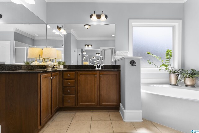 bathroom with double vanity, tile patterned floors, ornamental molding, a bath, and a stall shower