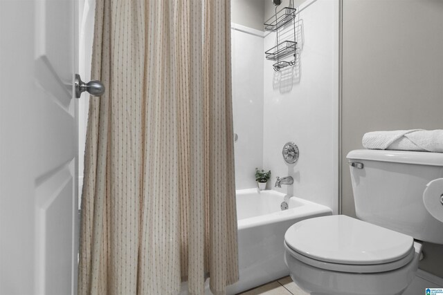 full bath with tile patterned floors, shower / bath combo, and toilet