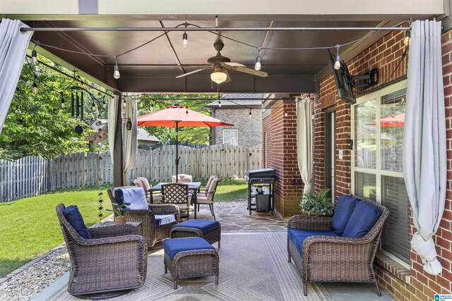 view of patio / terrace with an outdoor living space, ceiling fan, fence, and outdoor dining space