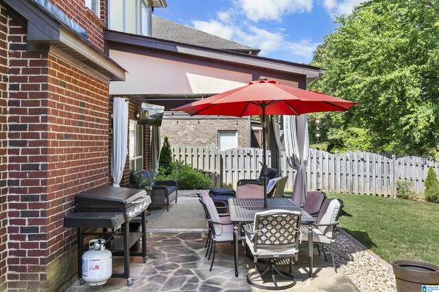 view of patio featuring fence and outdoor dining area