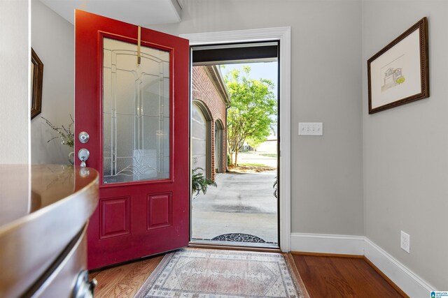entryway with baseboards and wood finished floors