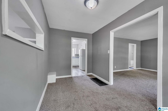 empty room with baseboards and carpet flooring