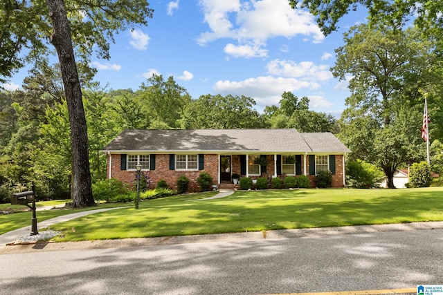 1700 Kestwick Dr, Hoover, AL 35226 - ranch-style home with roof with shingles, covered porch, a front yard, and brick siding