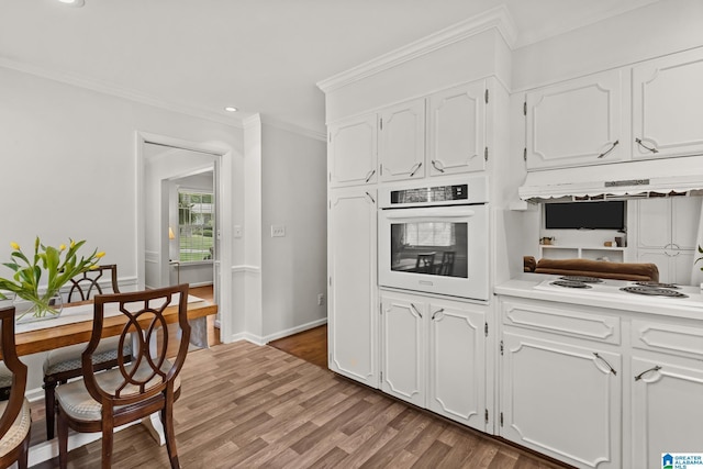 1700 Kestwick Dr, Hoover, AL 35226 - kitchen with ornamental molding, wood finished floors, white appliances, white cabinetry, and under cabinet range hood
