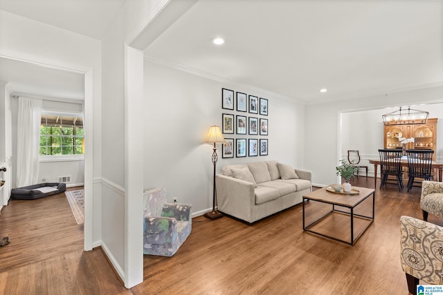 1700 Kestwick Dr, Hoover, AL 35226 - living area with an inviting chandelier, recessed lighting, crown molding, and wood finished floors