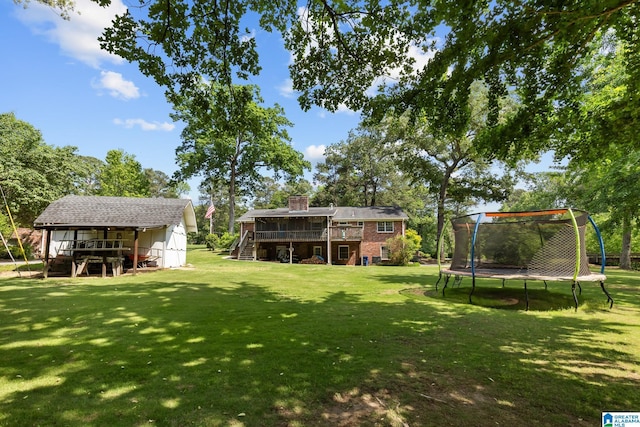 1700 Kestwick Dr, Hoover, AL 35226 - view of yard featuring stairs, an outbuilding, a trampoline, and a deck