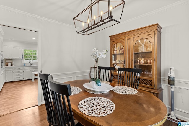 1700 Kestwick Dr, Hoover, AL 35226 - dining space with ornamental molding, light wood finished floors, a decorative wall, and a wainscoted wall