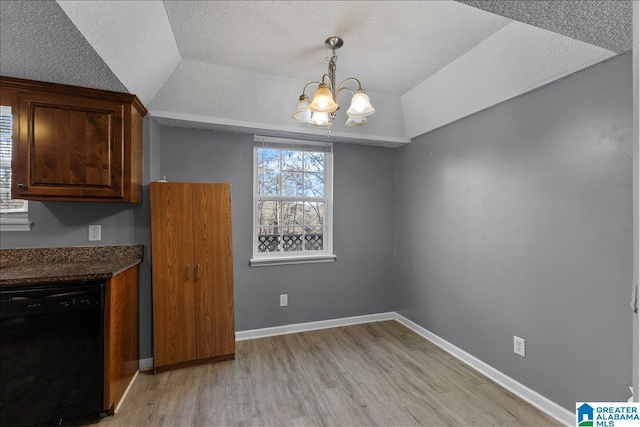 906 Ridgewood Dr, Remlap, AL 35133 - unfurnished dining area featuring a textured ceiling, a chandelier, light wood-style flooring, and lofted ceiling