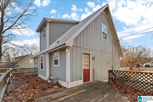 906 Ridgewood Dr, Remlap, AL 35133 - rear view of house featuring board and batten siding, a wooden deck, metal roof, and fence
