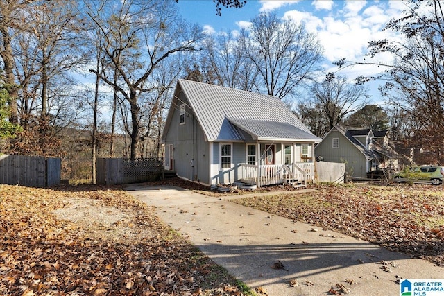906 Ridgewood Dr, Remlap, AL 35133 - view of front of home featuring fence, covered porch, driveway, and metal roof