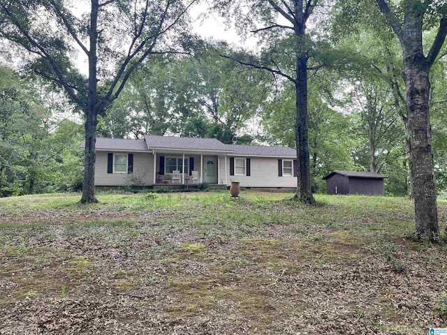 single story home with an outdoor structure, a porch, a shed, and crawl space
