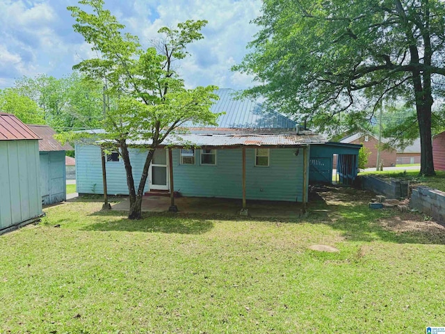103 Thatcher St, Piedmont, AL 36272 - rear view of property with metal roof, a yard, and entry steps