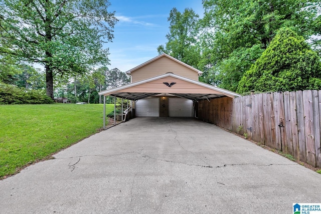 exterior space featuring a detached garage and fence
